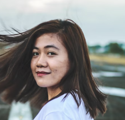 Young Asian woman smiling outdoors